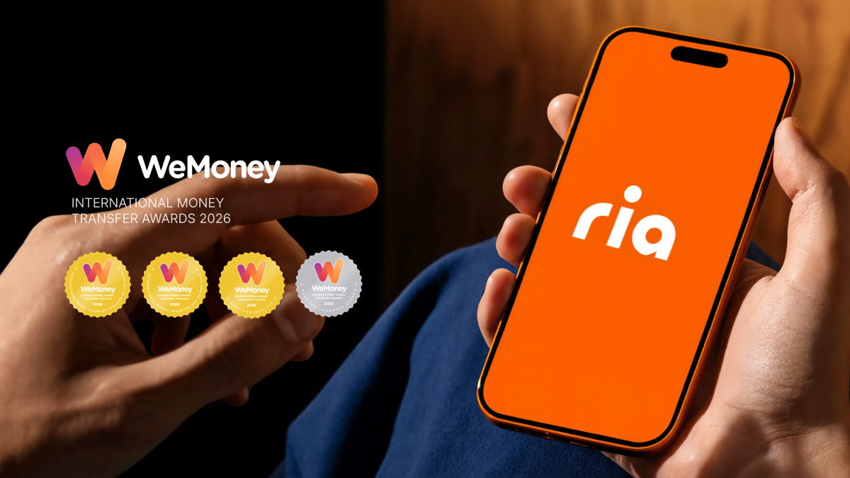RIA Money Transfer performance ad, hand holding a phone showing the ria app